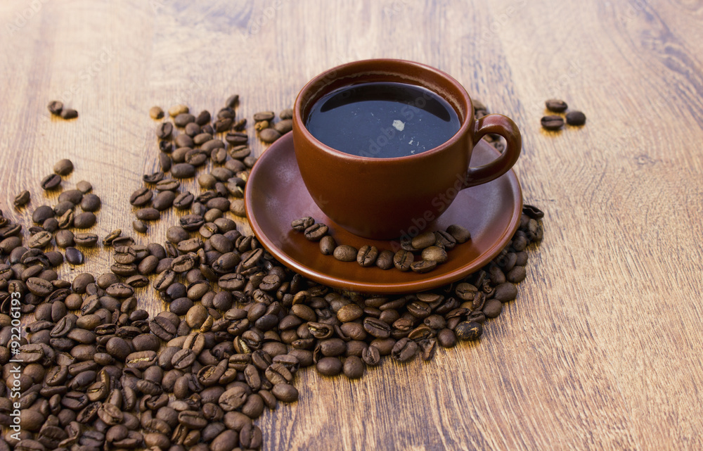 Cup of coffee on a wooden background with coffee beans Cup of coffee on a wooden background with coffee beans