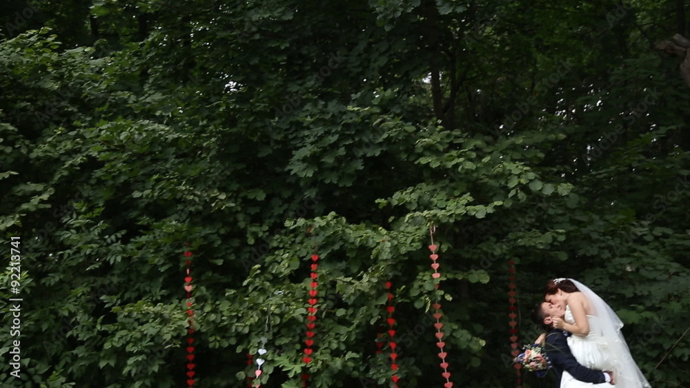 Beautiful bride and groom walk in the spring forest Beautiful bride and groom walk in the spring forest