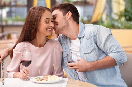 Attractive man and woman are relaxing in cafe