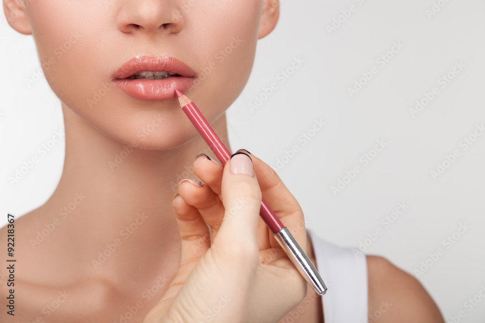 Cheerful young healthy woman is doing make-up Cheerful young healthy woman is doing make-up