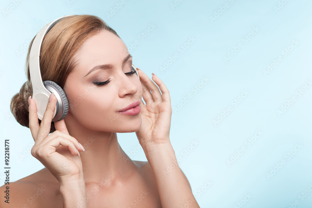 Attractive healthy girl is relaxing with earphones