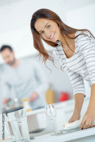 Woman setting the dining table