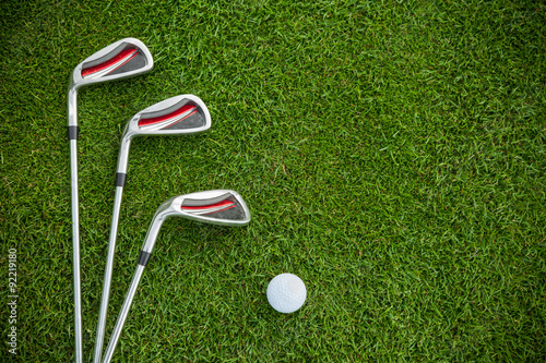Golf clubs and ball in grass