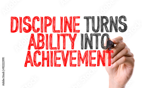 Hand with marker writing: Discipline Turns Ability Into Achievement