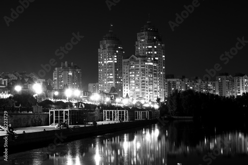 Lights night city with reflections on the river black and white