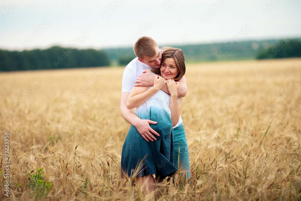 Outdoor portrait of young pregnant couple in field Outdoor portrait of young pregnant couple in field