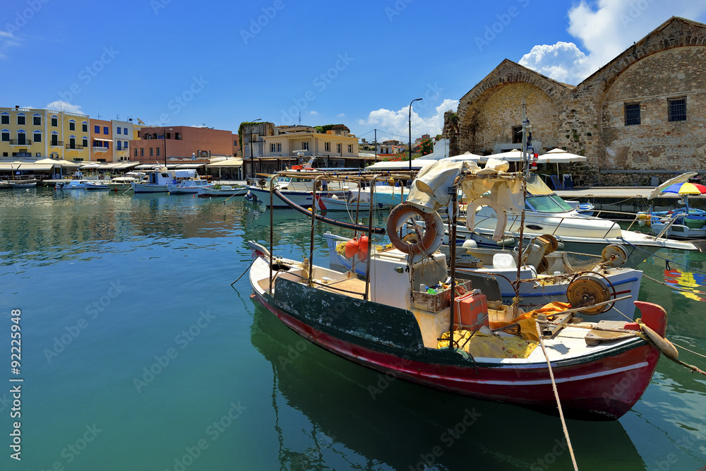 Wooden fishing boats in the beautiful small harbour Chania of Crete island in Greece