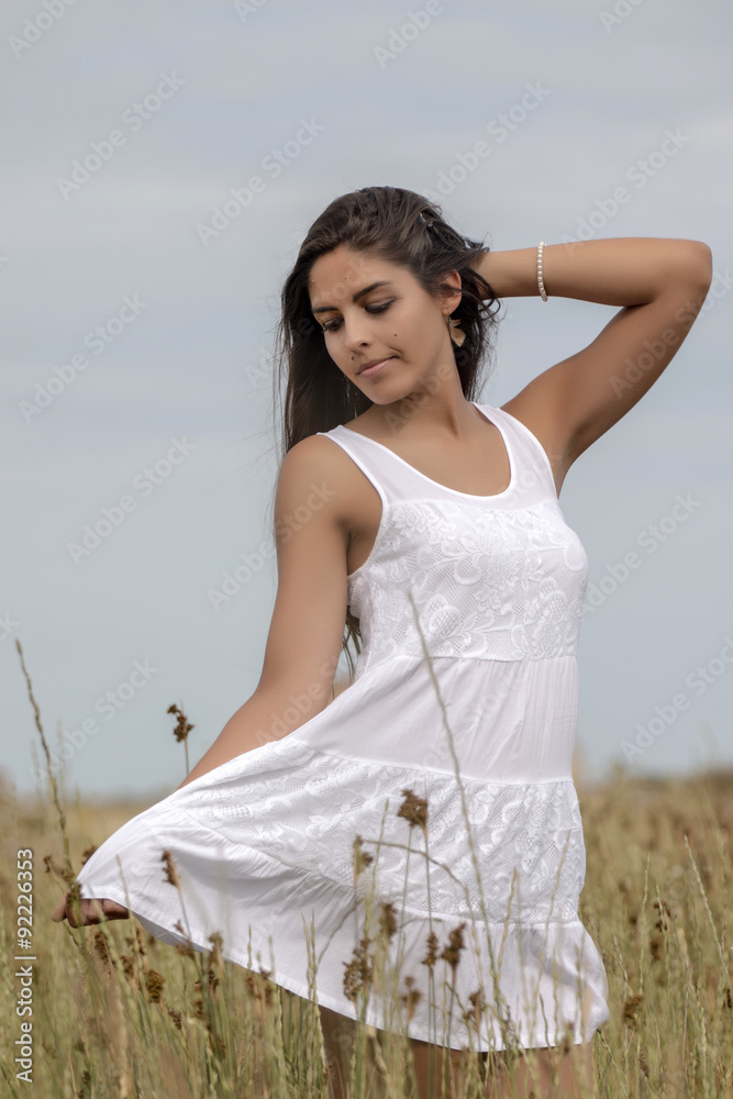 Close view of a beautiful woman on a white dress on the countryside. Close view of a beautiful woman on a white dress on the countryside.