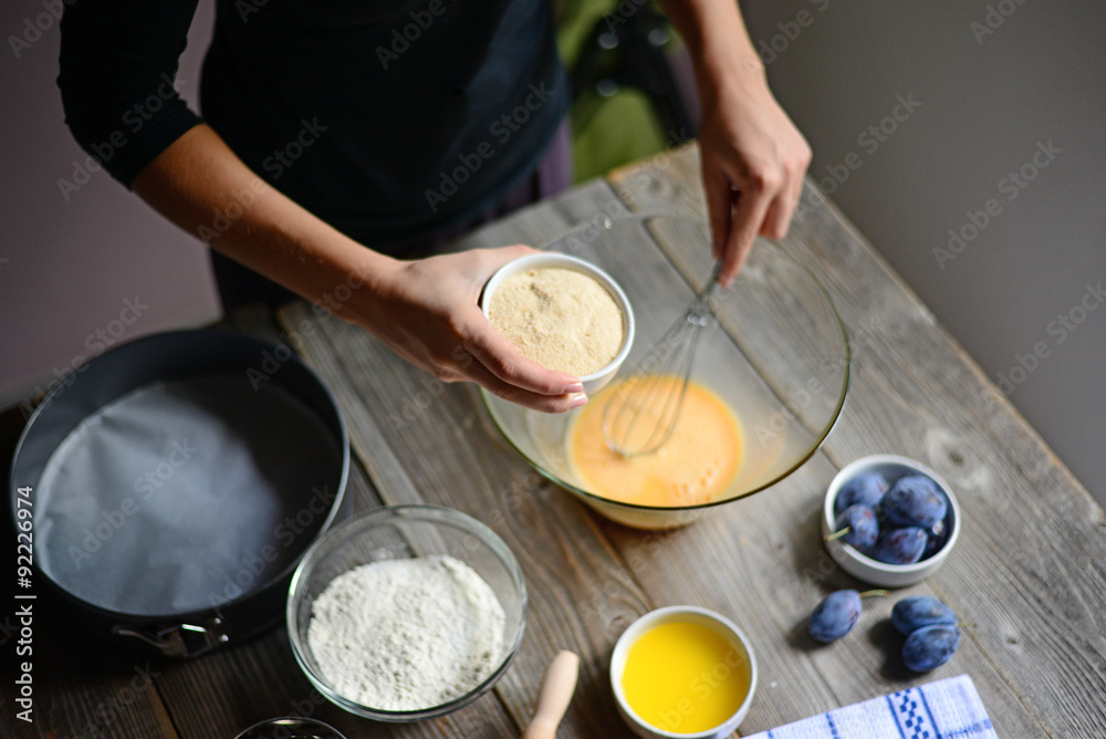 Baking: Woman prepare the eggs for butter and flour, and finally