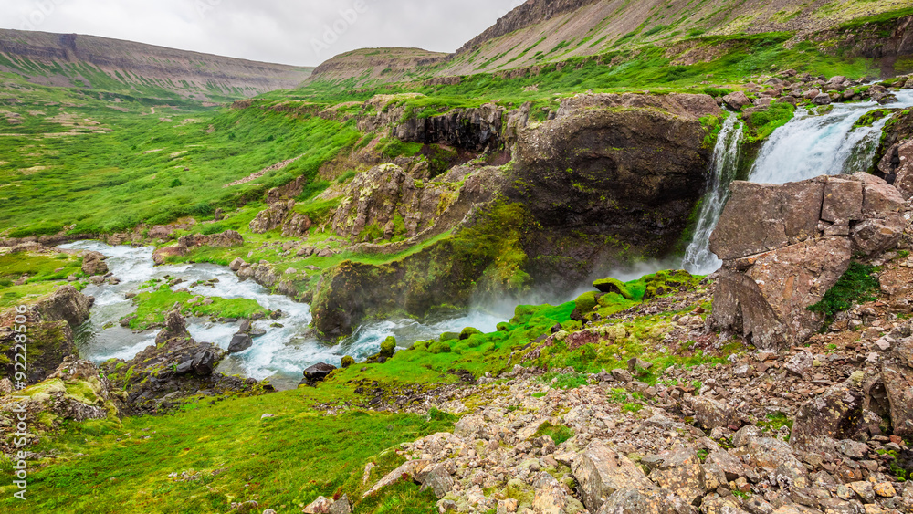 Water cascade in the mountains in Iceland Water cascade in the mountains in Iceland