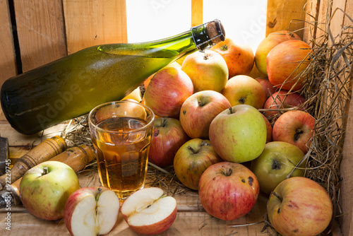 Photos bottle and glass of cider with apples
