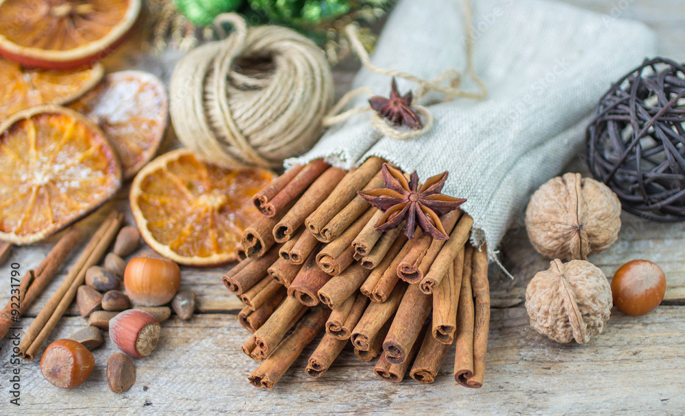 Cinnamon sticks, star anise and nuts on an old wooden table Cinnamon sticks, star anise and nuts on an old wooden table