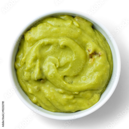 Round white bowl of tortilla guacamole dip isolated from above.
