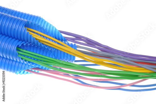 Colored electrical copper cables for electrician in corrugated pipe isolated over white background