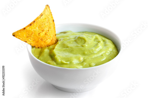 Round white bowl of guacamole dip isolated in perspective. Torti photo