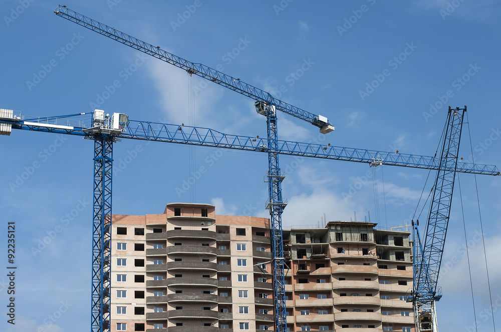 new house and three tall crane new house and three tall crane
