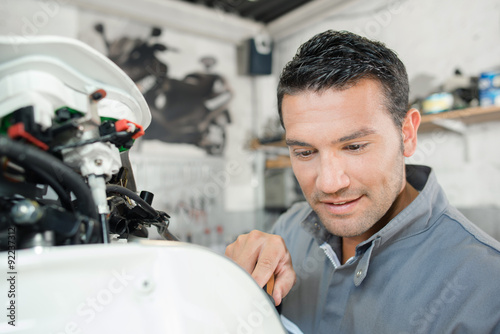 Mechanic working on a scooter