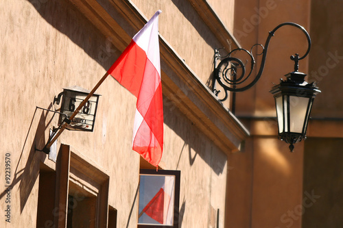 Polish flag and lantarn in background