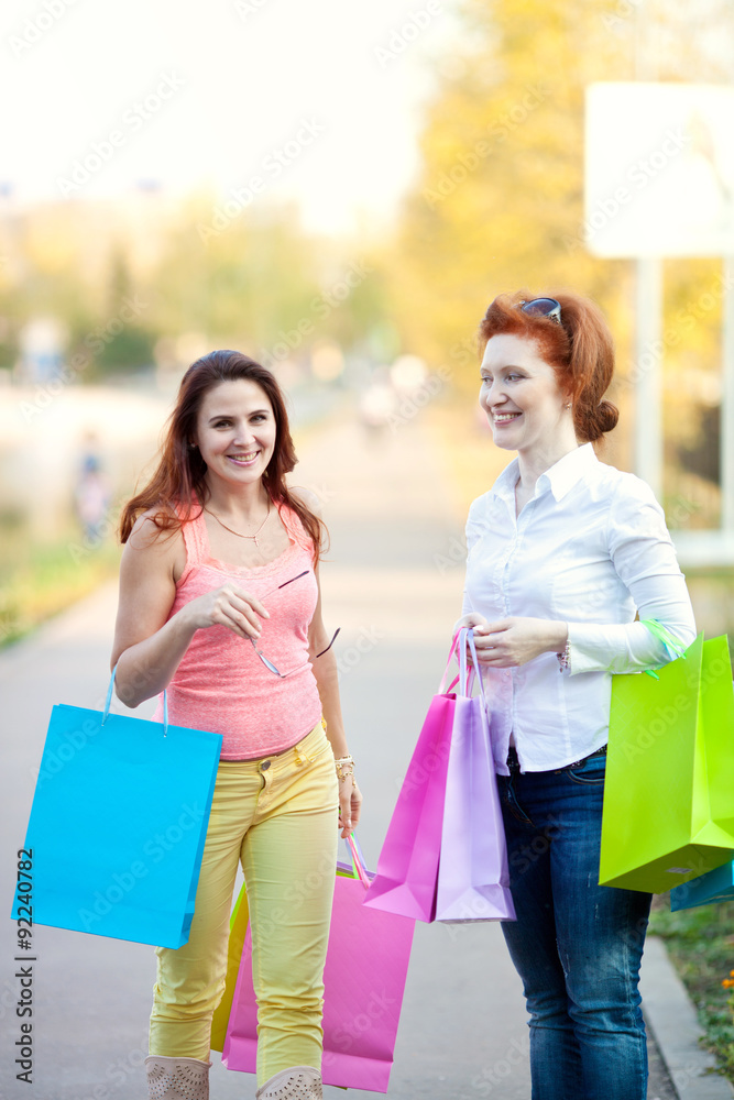 Two girls with bags on walk in autumn Two girls with bags on walk in autumn