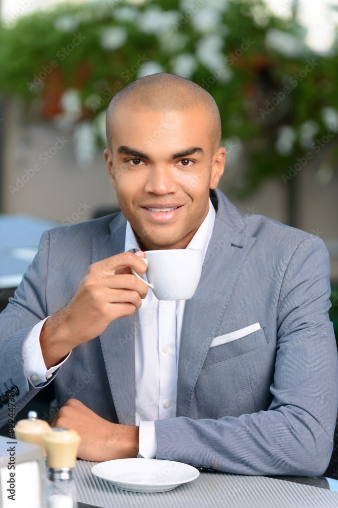 Pleasant businessman drinking coffee Pleasant businessman drinking coffee