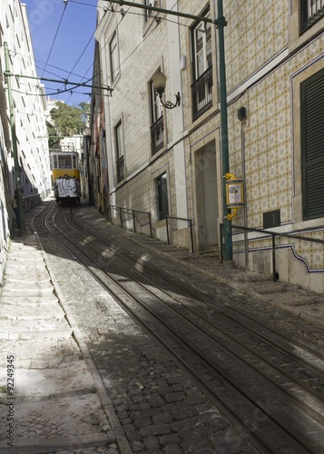 Lavra funicular in Lisbon in a sunny day, with wall decorated with traditional azulejos tile © greta gabaglio