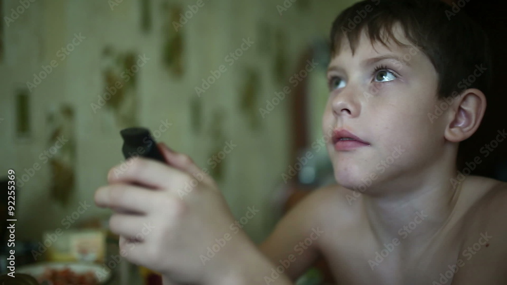 naked boy teenager changes channels TV remote control large face Stock ビデオ | Adobe Stock 