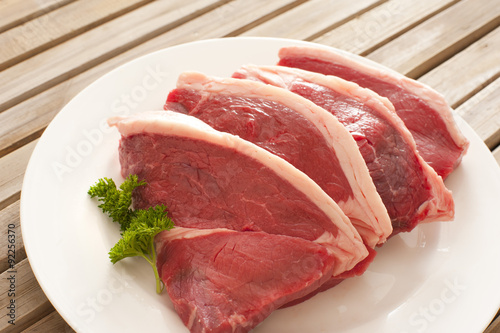 Four fresh raw beef steaks