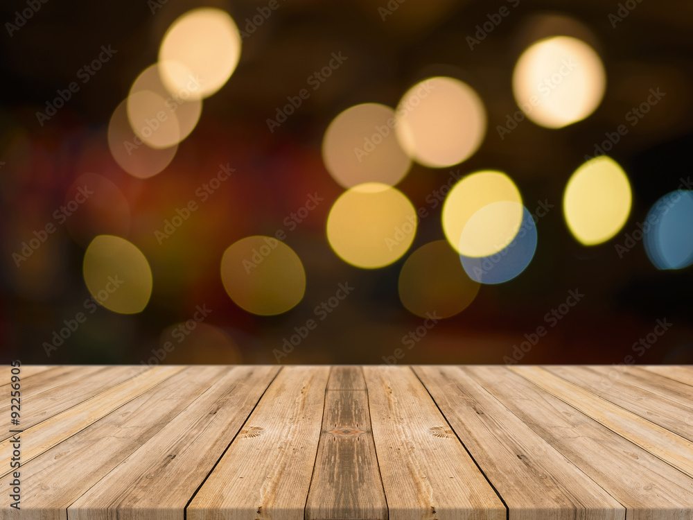 Wooden board empty table in front of blurred background. Perspective brown wood over bokeh light - can be used for display or montage your products. vintage filtered image.