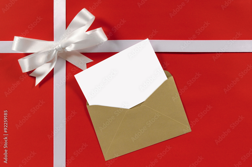 White gift ribbon and bow with greeting card for birthday or christmas present decoration on red wrapping paper background photo White gift ribbon and bow with greeting card for birthday or christmas present decoration on red wrapping paper background photo