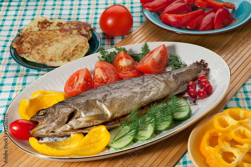 Trout baked in the oven on a country table