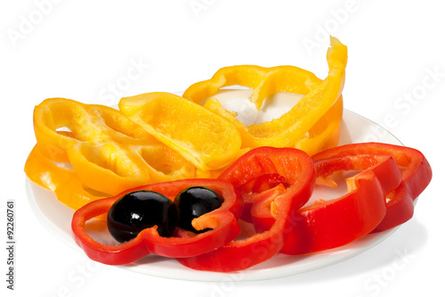 olives and slices of bell pepper red and yellow on a white plate