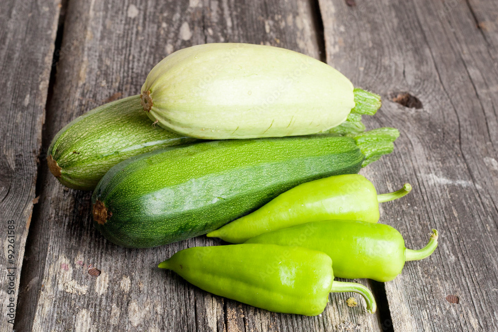 Pepper and Zucchini on wooden background Pepper and Zucchini on wooden background