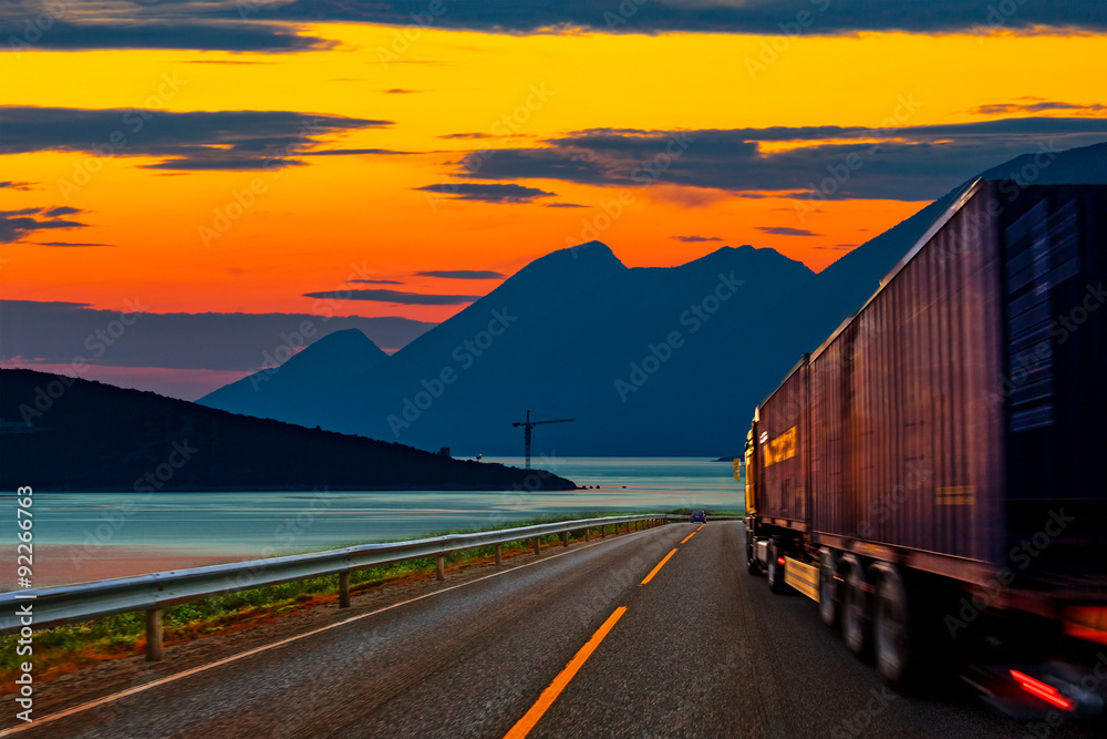 Truck traveling on the road at sunset. Truck traveling on the road at sunset.
