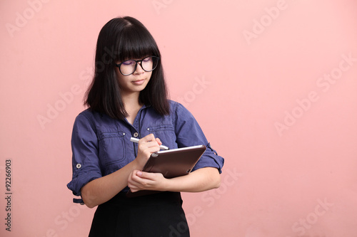 Asian teen writing tablet