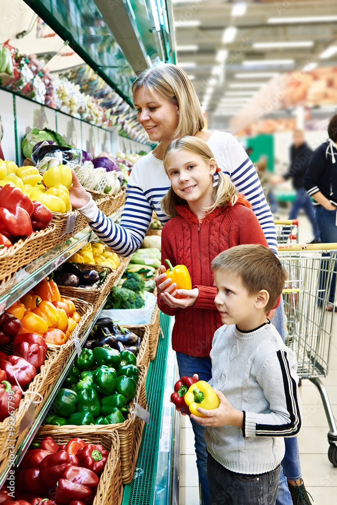 Mother and children with bell pepper in supermarket Mother and children with bell pepper in supermarket