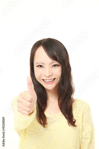 young Japanese woman with thumbs up gesture