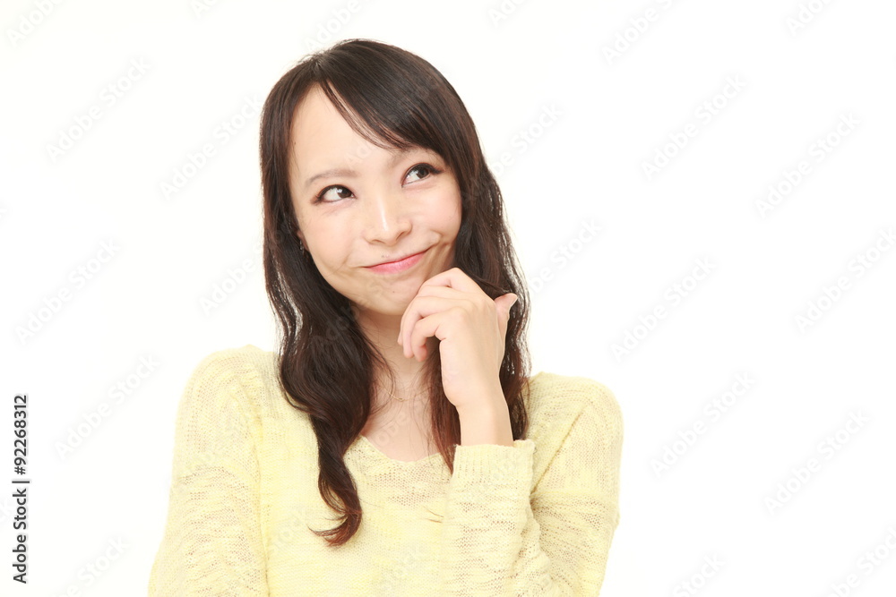 young Japanese woman thinks about something young Japanese woman thinks about something