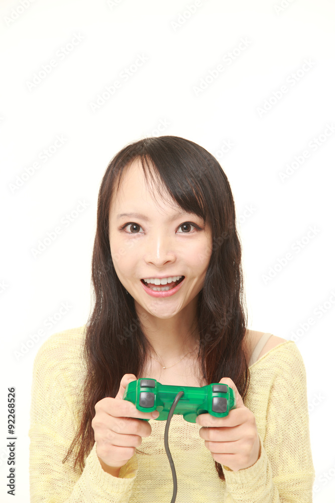 young Japanese woman enjoying a video game young Japanese woman enjoying a video game