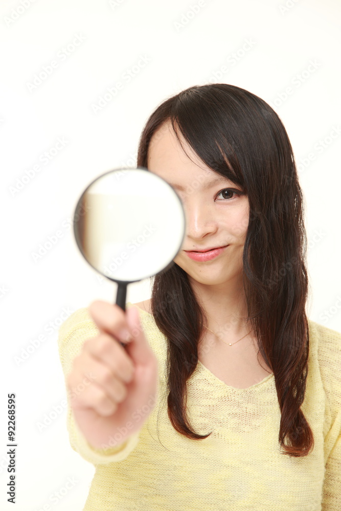 Japanese woman with a magnifying glass Japanese woman with a magnifying glass