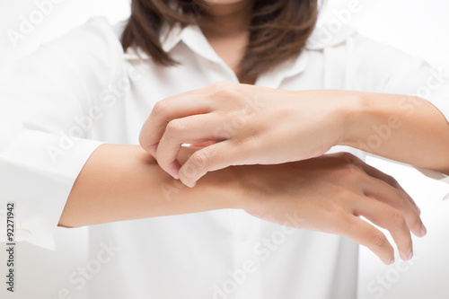 Woman scratching her arm