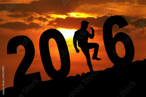 Person celebrating new year with 2016 number