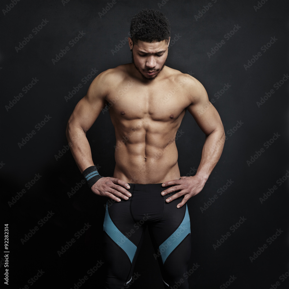 Fototapeta premium Athletic man on black wall background