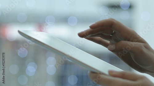 Close-up young woman using tablet