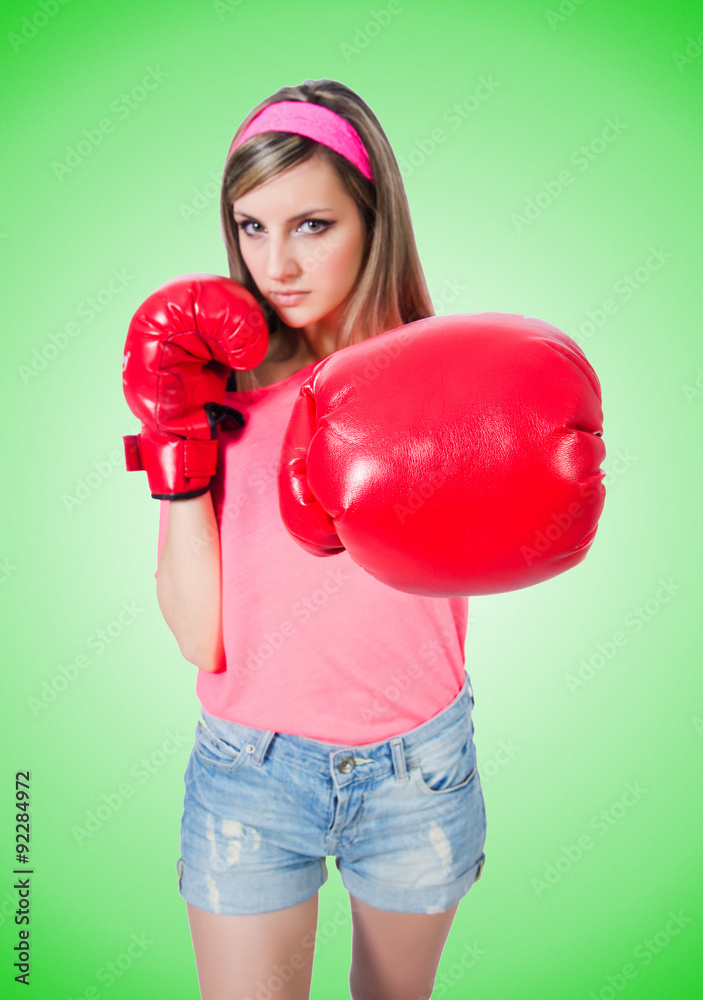 Young lady with boxing gloves on white Young lady with boxing gloves on white