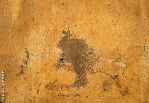 Texture of old wall covered with yellow stucco