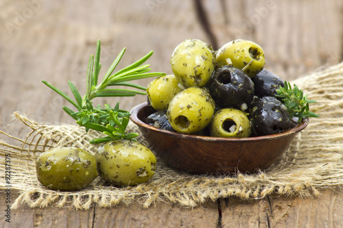black and green olives marinated with garlic and fresh mediterra photo
