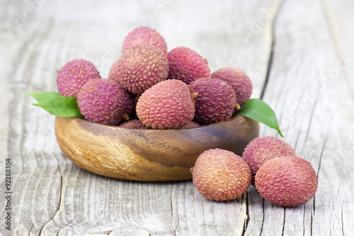 fresh lychees in a bowl  on wooden background