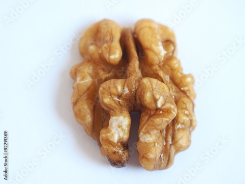 Shelled walnut seed on a white background. 