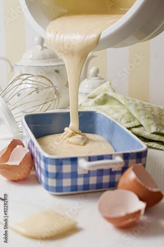 Tablou pe pânză Homemade yogurt sponge cake batter poured in blue ceramic dish