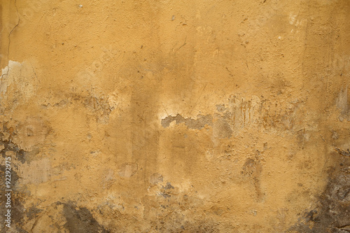 Texture of old wall covered with yellow stucco